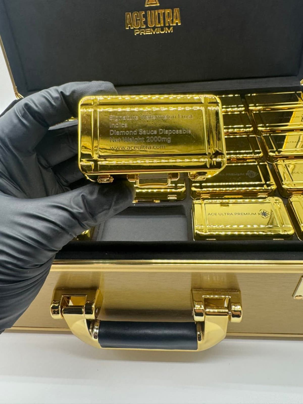 Ace Ultra Watermelon Frost engraved gold tin held in hand