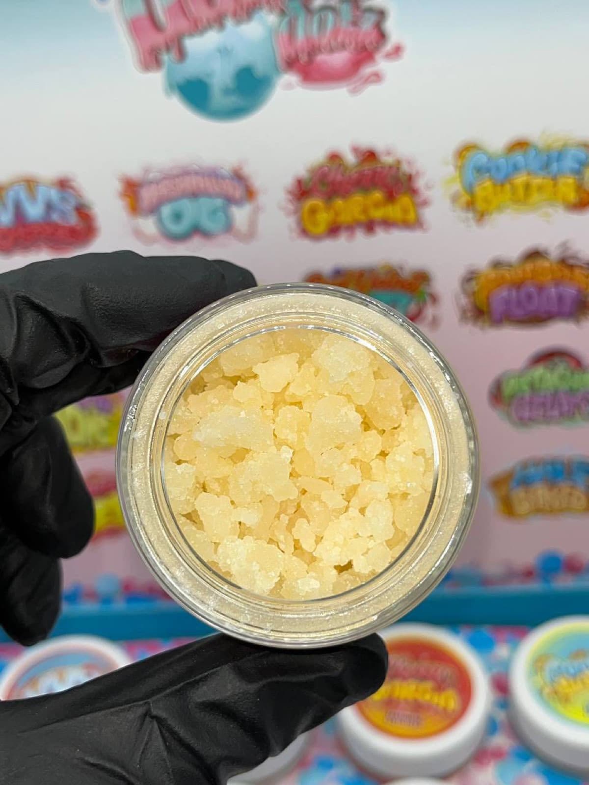 Open jar of golden sugar in front of Dabbin Dotz display