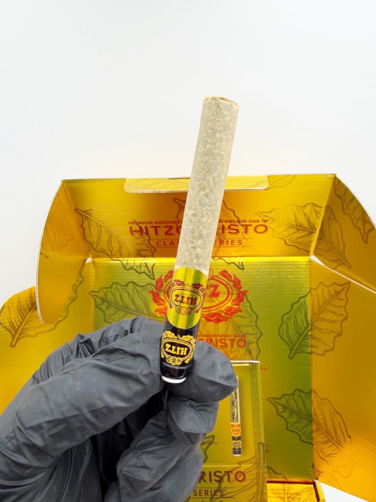 Hitzocristo pre-roll held above the box