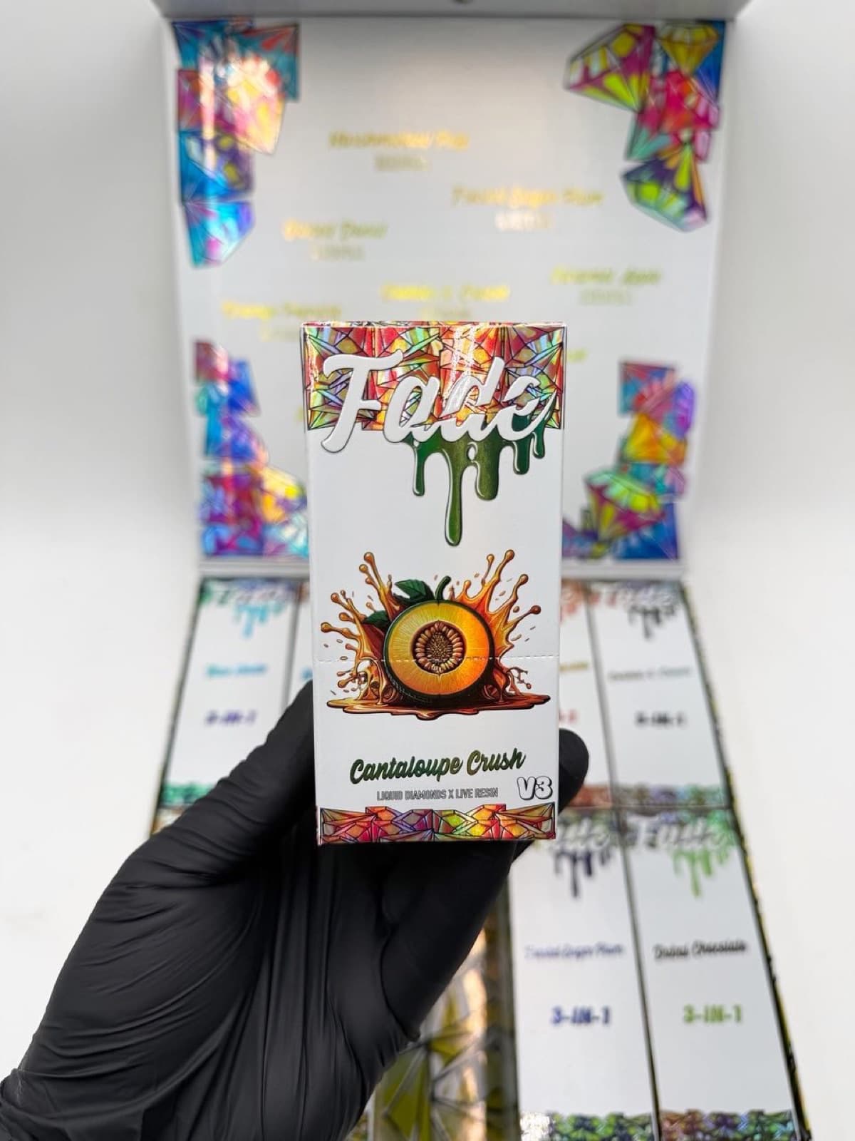 Fade V3 Cantaloupe Crush box held in hand