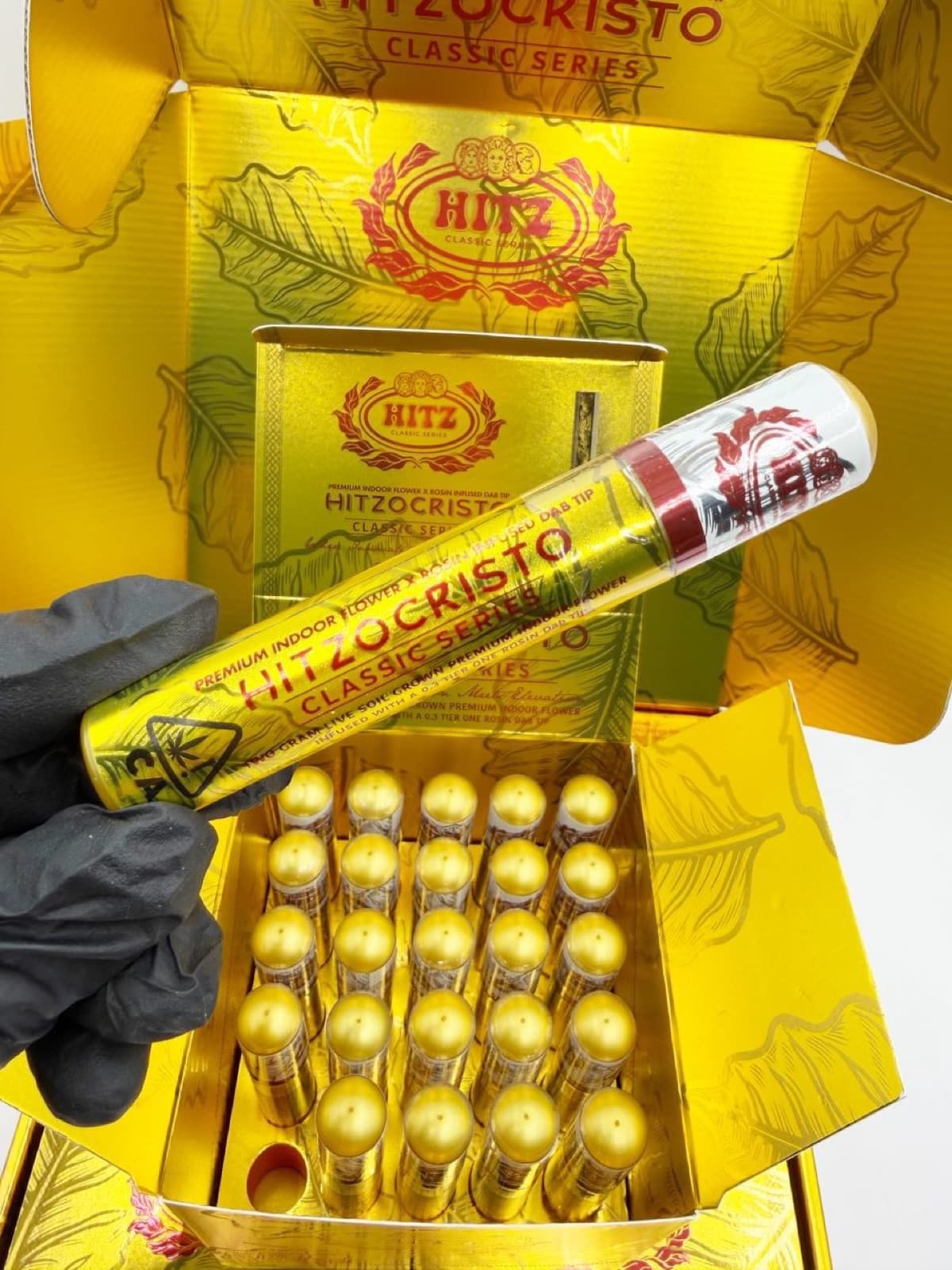 Hitzocristo gold tube held over open case